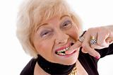 close up of old woman keeping finger in her mouth