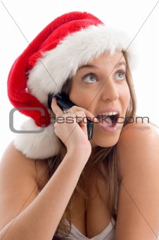 woman wearing christmas hat and talking on cell phone
