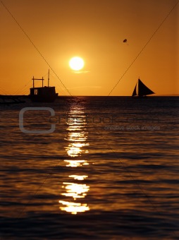 Drifting boat on a sunset