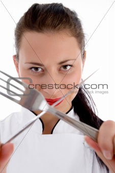 close up of female chef holding cutlery
