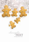 Gingerbread men cookies against sparkly white 