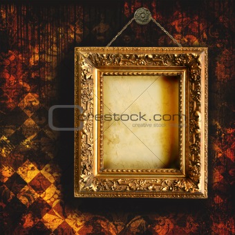 Grungy tattered wallpaper with empty picture frame
