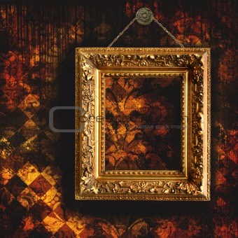 Grungy tattered wallpaper with empty picture frame
