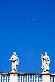 White classical statue and flying air in blue sky, Rome, Italy