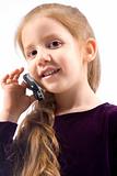 Young girl with talking on cell phone and smiling
