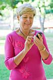 senior lady dial on a cell phone