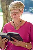 elderly woman reading bible