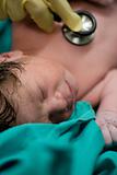 newborn baby boy checked by doctor