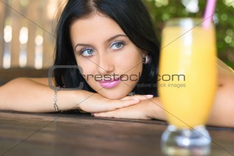 Young girl see on glass with juice