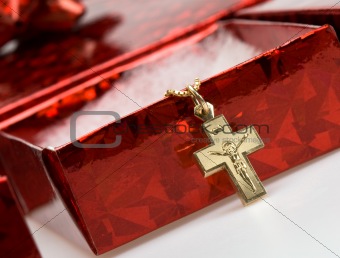 Red box with gold cross on chain