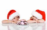 Happy kids near a plate with christmas cookies