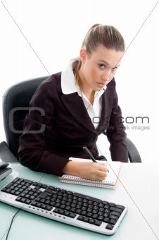 blonde professional writing on notebook