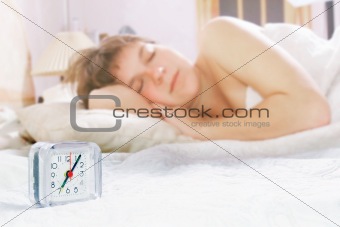 alarm clock on sleeping girl background