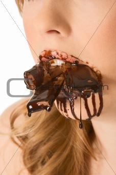 Sweets lover - mouth stuffed with chocolates