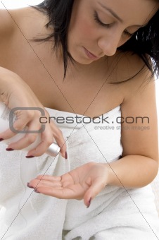 front view of woman taking lotion 