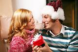 a couple in christmas time - he is holding a gift