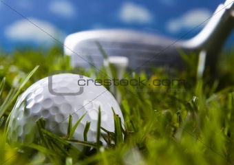 Golf ball on grass with driver