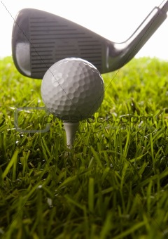 Golf club with ball on a tee & drive