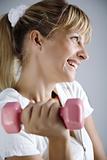 smiling female with dumbell