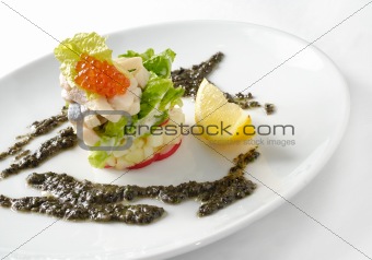 Decorated salad with caviar, fruits and fish