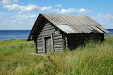 Old wooden shed on the lake bank