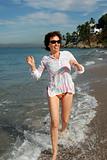 Happy woman running on the beach
