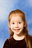 Portrait of grimacing redhead young girl with long hair