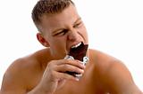 muscular guy eating chocolate