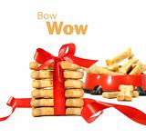 Dog biscuits  wrapped with red bow on white