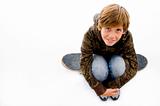 high angle view of boy sitting on skateboard 