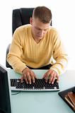 man typing something on computer