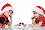 Kids with santa hats eating cookies