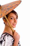 side view of smiling chineese woman holding an umbrella