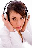 high angle view of serious woman listening music in headphones