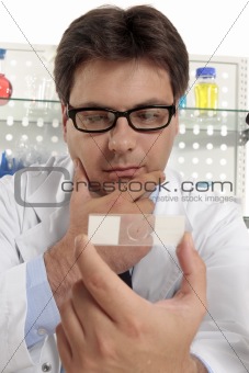Scientist studies a microscope slide