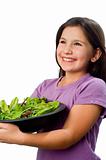 young girl holding plate with salad