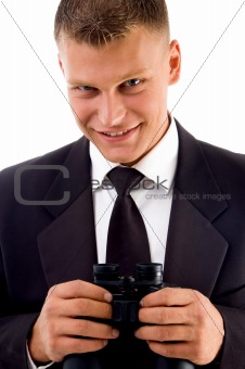 handsome young executive holding binoculars smiling