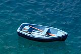 Rowboat in blue water, Santorini Greece