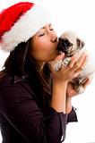 female with christmas hat and kissing puppy