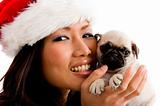 portrait of smiling woman with christmas hat and puppy 