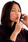 young corporate woman talking on cell phone and shushing