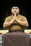 Asian man praying in temple