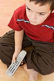 Little boy with a tv remote control