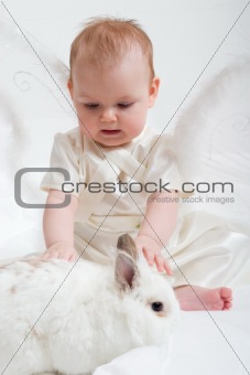 fairy plays with white rabbit