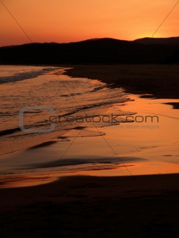 sand beach against purple sunset