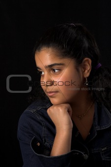 teen posing over black backdrop