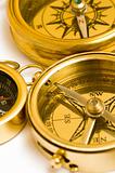 Three old style brass compasses