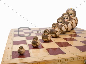 row of nested dolls on chessboard
