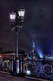 Old lantern on the bridge across Moskva River at night