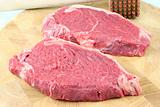 Steaks on a chopping board